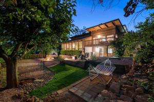 a backyard with a hammock in front of a house at Spacious Home-Walk to Uptown-Views-HotTub-GameRoom in Sedona