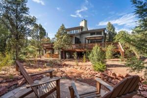 a house with two chairs in front of it at Uptown Cabin Home with Views HotTub near Trails in Sedona