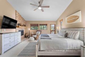 a bedroom with a bed and a ceiling fan at Uptown Cabin Home with Views HotTub near Trails in Sedona