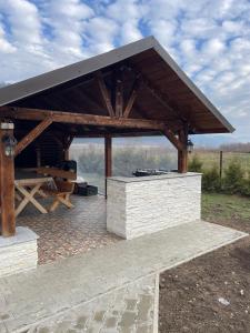 a pavilion with a roof on top of it at View Piatra Craiului in Zărneşti