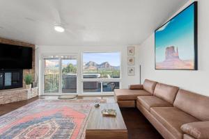 a living room with a couch and a flat screen tv at Luxury Uptown home with Views and Hot Tub in Sedona