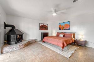 a bedroom with a bed and a fireplace at Luxury Uptown home with Views and Hot Tub in Sedona