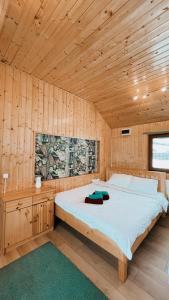 a bedroom with a bed in a wooden cabin at View Piatra Craiului in Zărneşti
