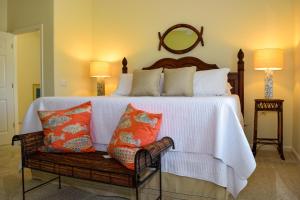 a bedroom with a large bed with orange and white pillows at Lakeside Beach House in Holmes Beach