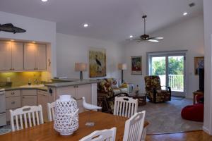 a kitchen and living room with a table and chairs at Lakeside Beach House in Holmes Beach