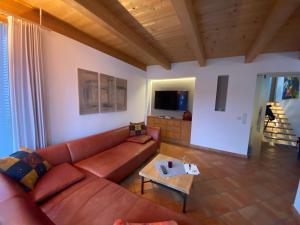 a living room with a couch and a table at Ferienhaus in Westendorf in Westendorf