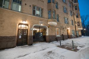 un edificio con puertas abiertas en la nieve en 2ndhomes Central & Cozy 1 BR Apartment in Kaisaniemi en Helsinki