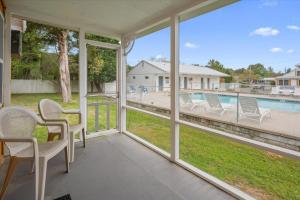 a porch with chairs and a view of a pool at Beach Bum West-O Cabins in Ocean City