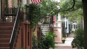 an american flag on a house in a street at Hotel Indigo Savannah Historic District by IHG in Savannah +70 photos
