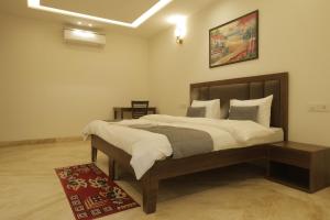 a bedroom with a large bed in a room at Under My Roof Superio in New Delhi