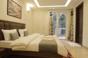 a bedroom with a large bed and a window at Under My Roof Superio in New Delhi