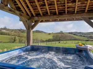 a hot tub with a view of a field at 5 Bed in Tiverton 48151 in Cadeleigh