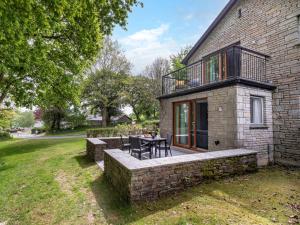 a stone house with a patio with a table at 2 Bed in St. Mellion 87707 in St Mellion