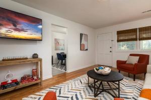 a living room with a couch and a table at Chic 2BR Durham Haven - Walk to Duke in Durham