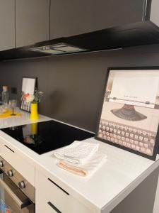a kitchen counter with a picture of a telephone at Exyca Metropolitano in Madrid