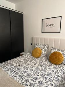 a bedroom with a bed with two yellow pillows at Exyca Metropolitano in Madrid