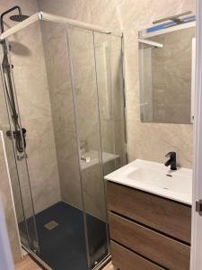 a bathroom with a shower and a sink at Exyca Metropolitano in Madrid