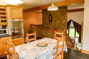 a kitchen and dining room with a table and chairs at The Mountain Lodge Slievenamon spacious 4 bedroom house in Cloneen