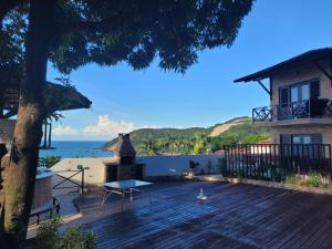 a house with a deck with a view of the ocean at Apartamentos Natal Ponta Negra Vista Espetacular para o Mar in Natal