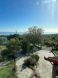 a view of a stone walkway with a bench at Villa_Kleio in Litochoro