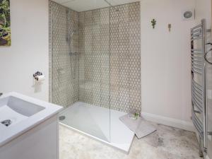 a white bathroom with a shower and a sink at 2 Bed in High Bickington 49558 in High Bickington +16 photos