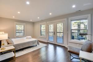 a bedroom with a bed and windows at Luxe Highlands Haven with Fire Pit and Hot Tub! in Highlands