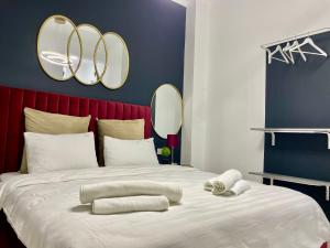 a bedroom with a large bed with mirrors on the wall at Metropole Apartments - Old City in Bucharest
