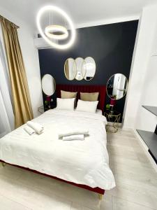 a bedroom with a large bed with mirrors on the wall at Metropole Apartments - Old City in Bucharest