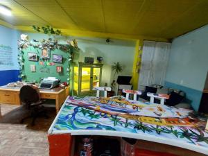 a room with a bed and a desk with a computer at MACONDO apartamento turistico tematico in Zipaquirá