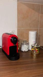 a red toaster sitting on top of a wooden table at Apartment 70 m² drei Personen Prag kourimka 30 in Prague