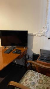 a desk with a computer monitor and a laptop on it at Apartment 70 m² drei Personen Prag kourimka 30 in Prague