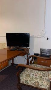 a desk with a computer monitor on top of it at Apartment 70 m² drei Personen Prag kourimka 30 in Prague