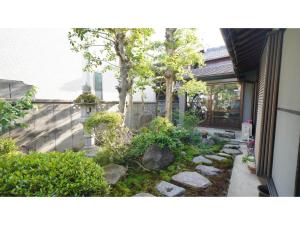 a garden with rocks and trees in front of a house at Uji Tea Inn - Vacation STAY 27194v in Uji