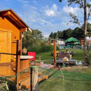 a wooden cabin with a deck and a table at Biwako Hills - Vacation STAY 27838v in Takashima
