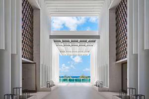 a hallway in a building with a view of the ocean at Wyndham Grand Barbados Sam Lords Castle All Inclusive Resort in Saint Philip