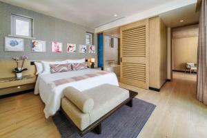 a large bedroom with a large bed and a bathroom at Wyndham Grand Barbados Sam Lords Castle All Inclusive Resort in Saint Philip