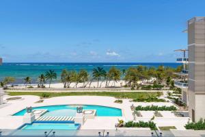 an aerial view of a resort with a swimming pool and the beach at Wyndham Grand Barbados Sam Lords Castle All Inclusive Resort in Saint Philip