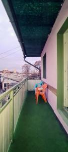 a balcony with a table and two chairs on it at Roots Hostel in Chişinău