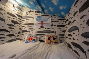 a bed in a room with a wall covered in animals at Nakanishiso 2F - Vacation STAY 30052v in Tokyo