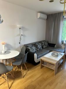 a living room with a couch and a table at Alex Beach in Elenite