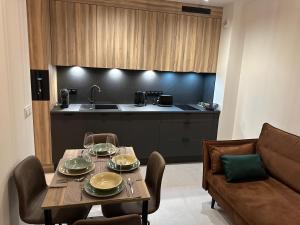 a kitchen with a table and a couch and a table and chairs at Apartamenty Czarne Owce in Szklarska Poręba +15 photos