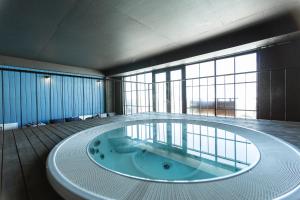 a large bathroom with a large tub in the middle at Hotel Roshe Gudauri in Gudauri