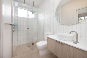 a bathroom with a toilet and a sink and a mirror at Surrey Sunset Sanctuary in McCrae in McCrae +18 photos