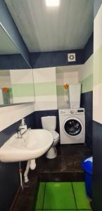 a bathroom with a sink and a washing machine at Roots Hostel in Chişinău