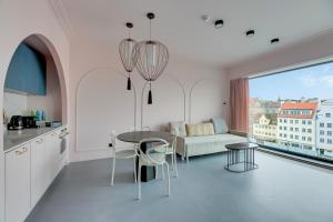 a kitchen and living room with a table and a couch at Deo Plaza Prestige 1 by Grand Apartments in Gdańsk