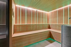 a sauna with wooden benches with lights on it at Deo Plaza Prestige 1 by Grand Apartments in Gdańsk