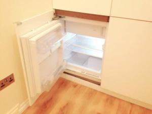 an empty refrigerator with its door open in a kitchen at Soho China Town Rooms in London