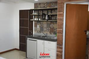 a kitchen with a sink and a shelf at Ideas Temporarios in Paso de los Libres
