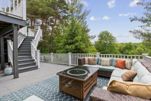 a patio with a couch and a table on a deck at Modern Provincial Farmhouse I Outdoor Oasis in Chagrin Falls