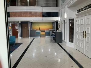 an empty lobby with a door open to a building at La Quinta by Wyndham OKC North - Quail Springs in Oklahoma City